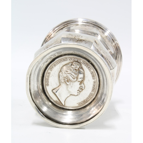 36 - Swedish silver beaker of fluted design, the base inset with a commemorative coin, 10cm high