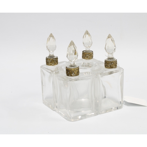 396 - 19th century scent bottle stand, likely French, four bottles with metal collars & cut glass stoppers... 