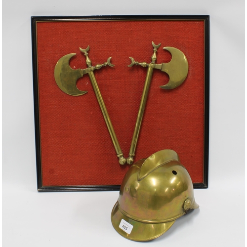 405 - Fireman's brass helmet together with a framed pair of brass axes. (2)