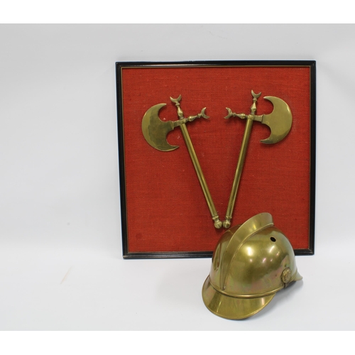 405 - Fireman's brass helmet together with a framed pair of brass axes. (2)