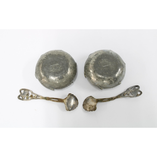53 - A pair of French Arts & Crafts pewter salts with matching spoons by AE Chanal, (4)