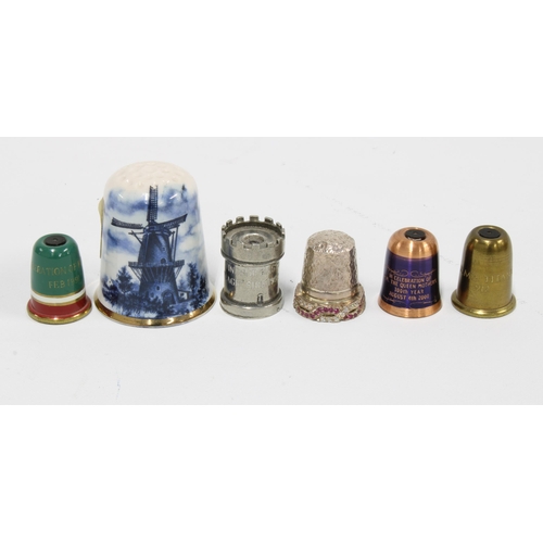 79 - A silver paste set thimble, Birmingham 1992, three Stanhope type thimbles, another castellated thimb... 