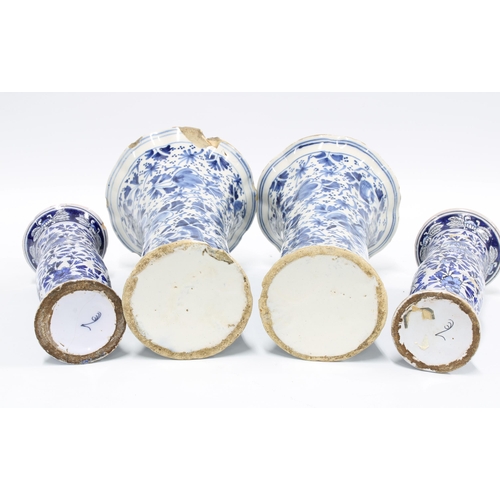 83 - A pair of delft blue and white vases with frilled rims and floral pattern together with a pair of sm... 