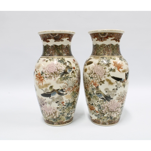 84 - Pair of Japanese earthenware vases typically decorated with birds and chrysanthemums, each with eigh... 