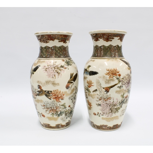 84 - Pair of Japanese earthenware vases typically decorated with birds and chrysanthemums, each with eigh... 