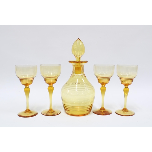 93 - Early 20th century amber glass decanter with stopper and set of four glasses (5) 17cm.