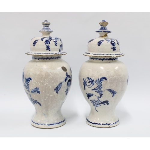 98 - A pair of delft blue and white lidded vases with mixed flowers and wavy bottom border, (2) (some dam... 