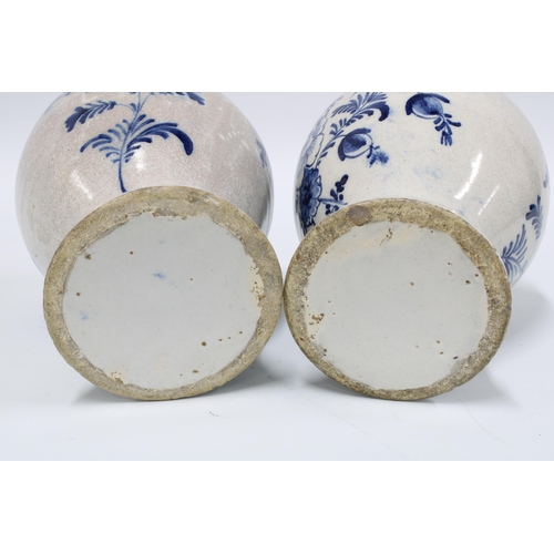 98 - A pair of delft blue and white lidded vases with mixed flowers and wavy bottom border, (2) (some dam... 