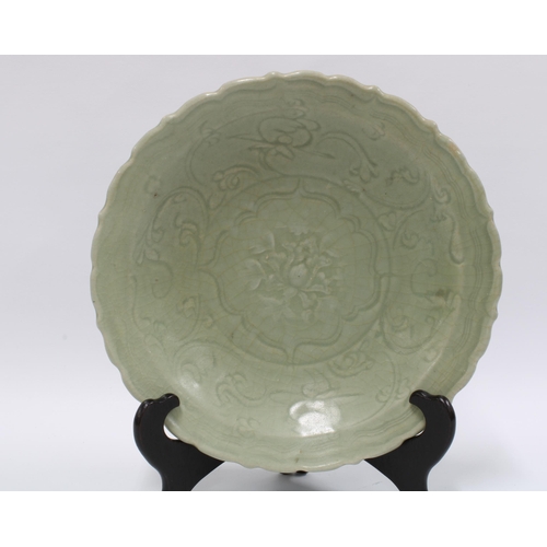 99 - Chinese Qingbai dish / shallow bowl, the celadon ground with carved lotus pattern, wavy edged rim, u... 