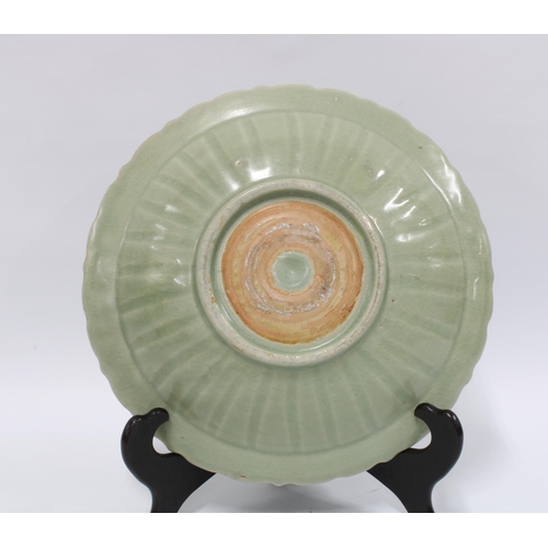 99 - Chinese Qingbai dish / shallow bowl, the celadon ground with carved lotus pattern, wavy edged rim, u... 