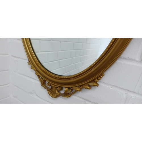 416 - Reproduction faux gilt framed mirror with a classical urn surmount over an oval mirrored plate. 79 x... 