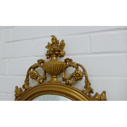 416 - Reproduction faux gilt framed mirror with a classical urn surmount over an oval mirrored plate. 79 x... 