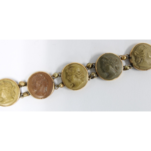 25 - Lava cameo brooch with twelve panels set in gold, stamped 14K
