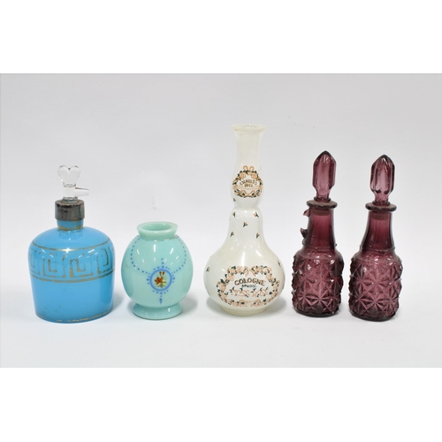 105 - Four glass perfume bottles to include one  inscribed Charles of The Ritz - Moss Rose, together with ... 