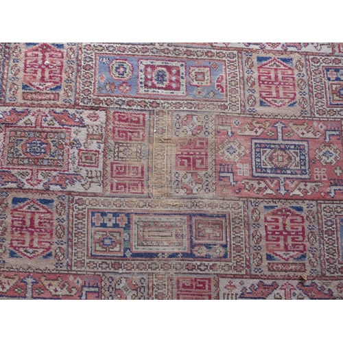 200 - Large Eastern carpet, pink field with allover pattern of square panels within flowerhead borders, ev... 