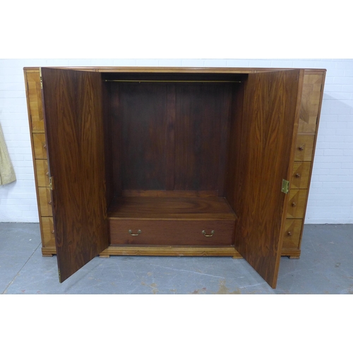 201 - Whytock & Reid walnut wardrobe, flat top with rounded edge over a pair of central robe doors which o... 