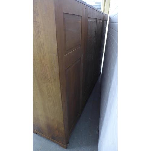 201 - Whytock & Reid walnut wardrobe, flat top with rounded edge over a pair of central robe doors which o... 