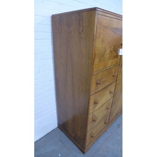 201 - Whytock & Reid walnut wardrobe, flat top with rounded edge over a pair of central robe doors which o... 