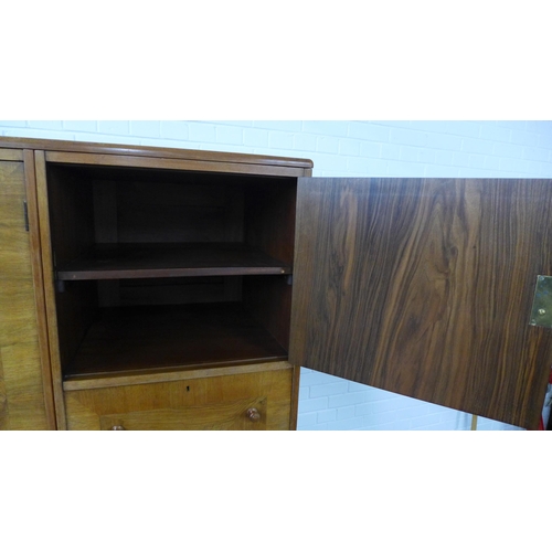 201 - Whytock & Reid walnut wardrobe, flat top with rounded edge over a pair of central robe doors which o... 