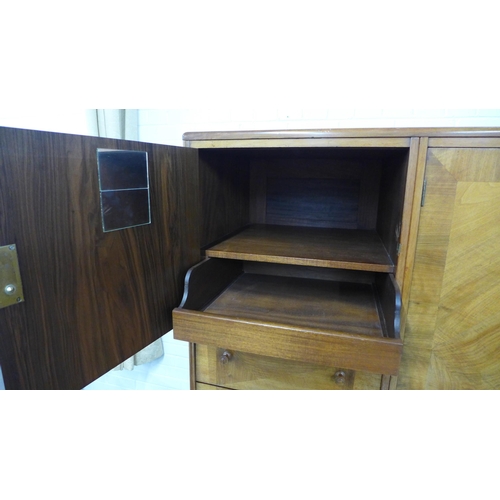 201 - Whytock & Reid walnut wardrobe, flat top with rounded edge over a pair of central robe doors which o... 