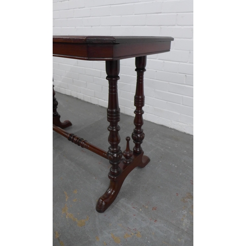 214 - Mahogany writing / side table, rectangular top with canted corners, on twin supports with ring turne... 