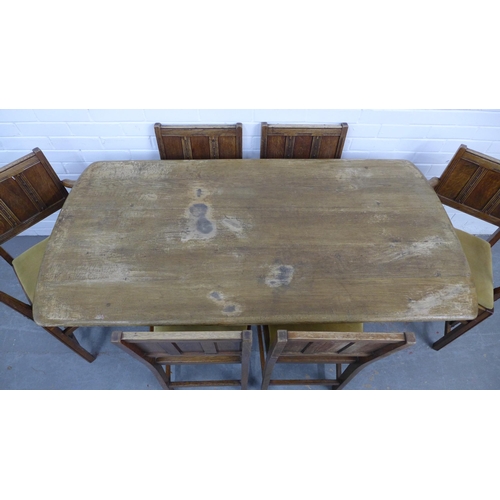 220 - An Ercol oak dining table and set of six Jacobean style chairs with slip in seats. 72 x 153 x 77cm. ... 