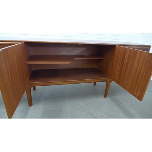 233 - A.H. McIntosh, teak sideboard with a pair of cupboard doors, flanked on one side to a fall front, an... 