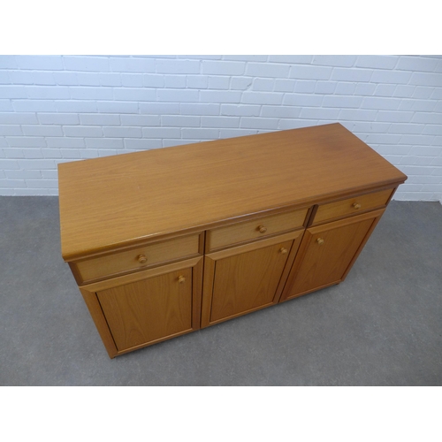 246 - Teak sideboard, three short drawers and three panelled doors, 77 x 124 x 45cm.