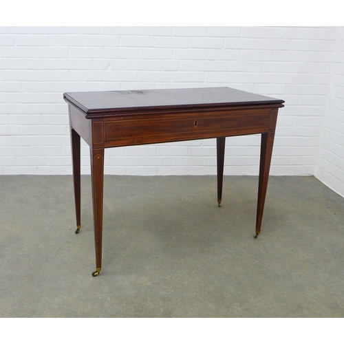 263 - Edwardian mahogany and inlaid foldover tea table with frieze drawer on tapering leg, on brass caps a... 