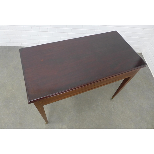 263 - Edwardian mahogany and inlaid foldover tea table with frieze drawer on tapering leg, on brass caps a... 