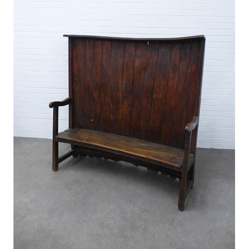 290 - An antique oak high back wooden settle with concave panelled back, solid seat and open arms, 146 x 1... 