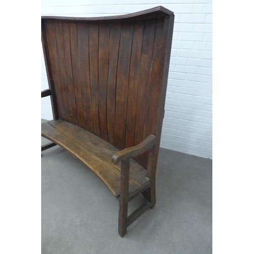 290 - An antique oak high back wooden settle with concave panelled back, solid seat and open arms, 146 x 1... 