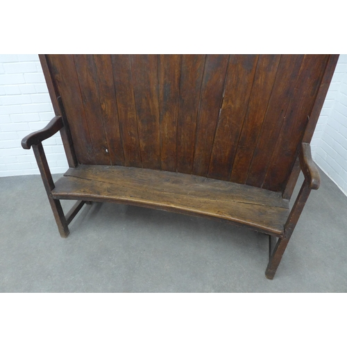 290 - An antique oak high back wooden settle with concave panelled back, solid seat and open arms, 146 x 1... 