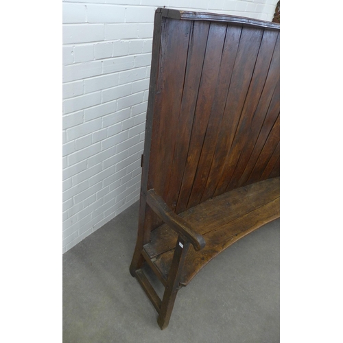 290 - An antique oak high back wooden settle with concave panelled back, solid seat and open arms, 146 x 1... 