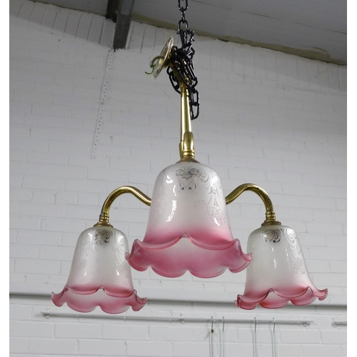 298 - Christopher Wray brass three branch light fitting with pink and white glass shades, 40cm.