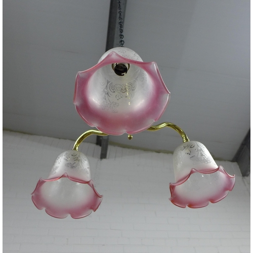 298 - Christopher Wray brass three branch light fitting with pink and white glass shades, 40cm.