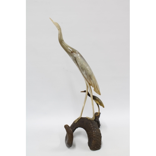 309 - Cow horn model of two birds bird on a rams horn base, 62cm.