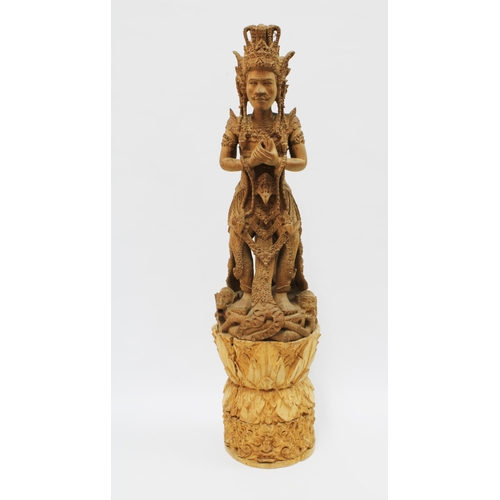 310 - Eastern deity, carved wooden figure on a tall base, possibly Indian (in two parts) 69cm.