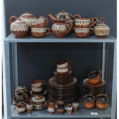 323 - A quantity of Romanian or eastern european brown glazed pottery to include tea sets, miniature vases... 