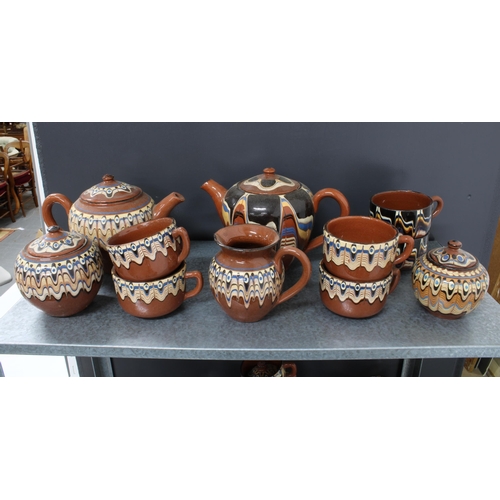 323 - A quantity of Romanian or eastern european brown glazed pottery to include tea sets, miniature vases... 