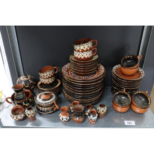 323 - A quantity of Romanian or eastern european brown glazed pottery to include tea sets, miniature vases... 