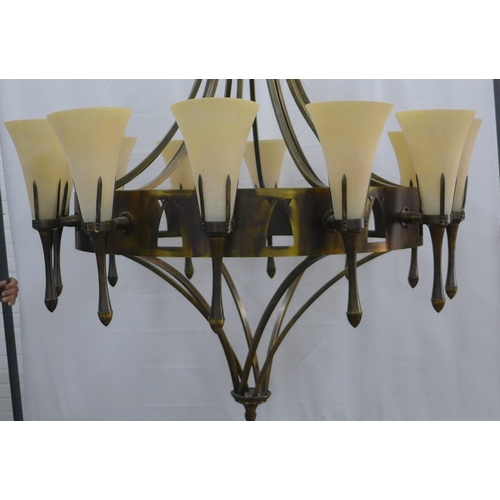 325 - Chelsom bronze patinated chandelier, circular frame with twelve sconce arms with fluted glass shades... 