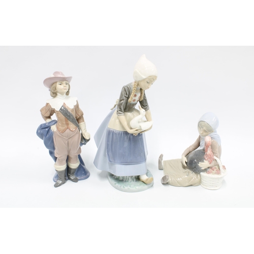 329 - Lladro figures  ‘Musketeer Athos’  No 6121, girl with goose and another (3) 27cm.