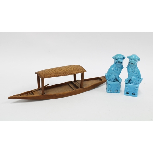 338 - A pair of Chinese turquoise glazed Temple Lions / Dogs of Fo and a wooden boat with paddle, (3)