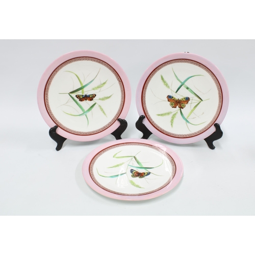 358 - Three 19th century porcelain plates, pink rims and butterfly patterns (3) 23cm.