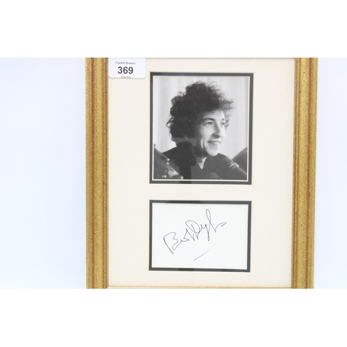 369 - Bob Dylan autograph on white card and signed in black ink mounted with a black and white photograph ... 