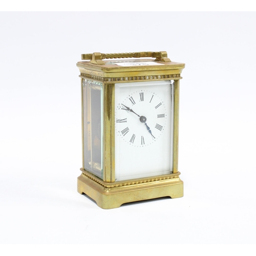 375 - Brass and glass panelled carriage clock, roman numerals, with key, 14cm high including handle