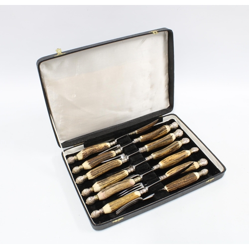 390 - Cased set of six horn handled knives and forks, with metal pommel ends