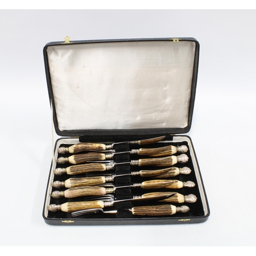 390 - Cased set of six horn handled knives and forks, with metal pommel ends