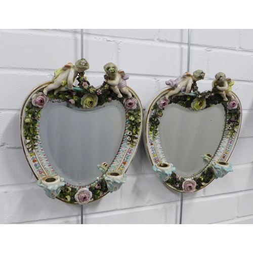 410 - Pair of continental porcelain wall mirrors / candle sconces, heart shaped with cherubs and floral en... 